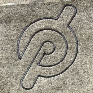 Peloton “P” embroidered grey, wool blend throw blanket.